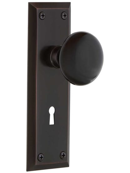 New York Style Door Set with Black Porcelain Knobs in Timeless Bronze.